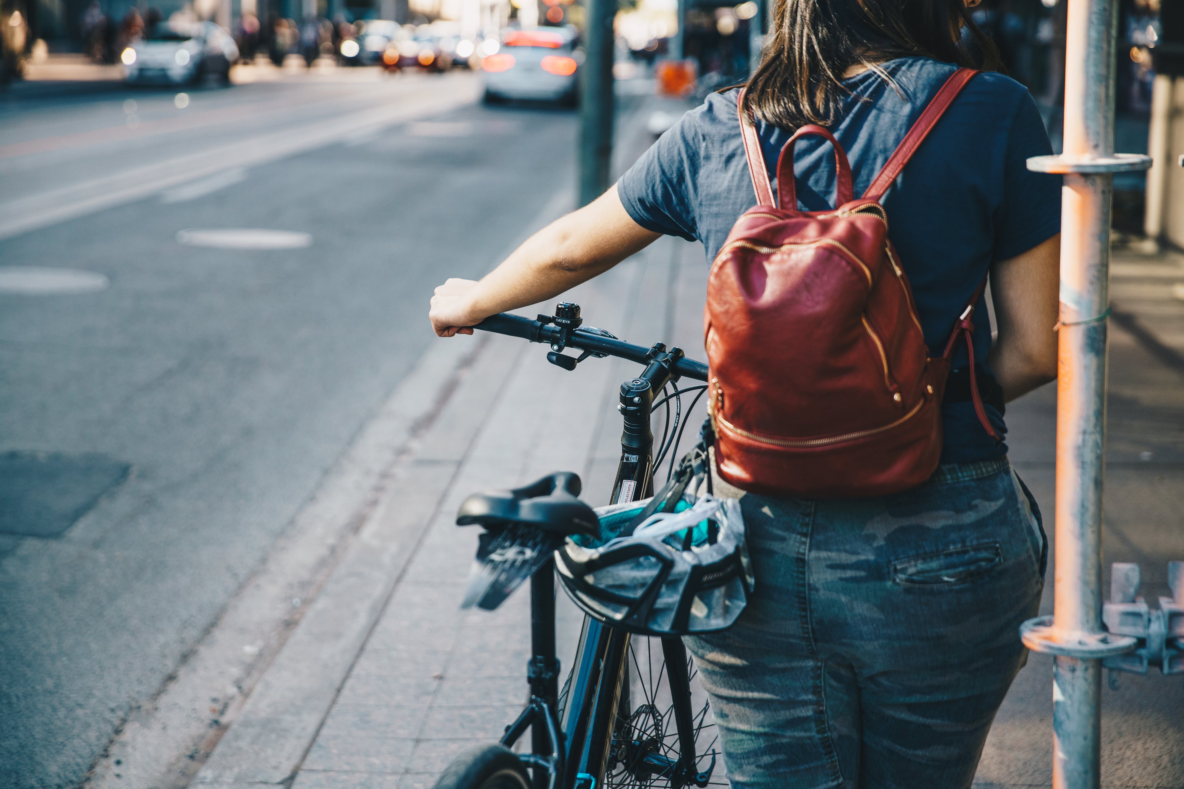 person-walking-bike-on-sidewalk.jpg